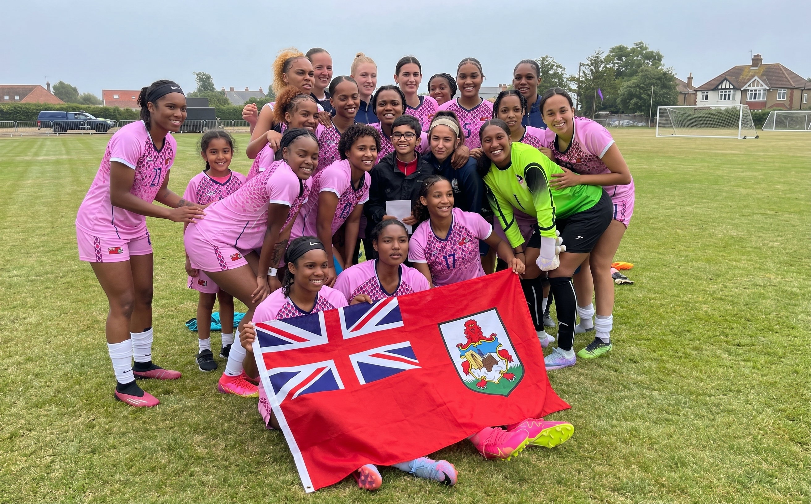 Bermuda women's national football team celebrating with the Bermuda flag
